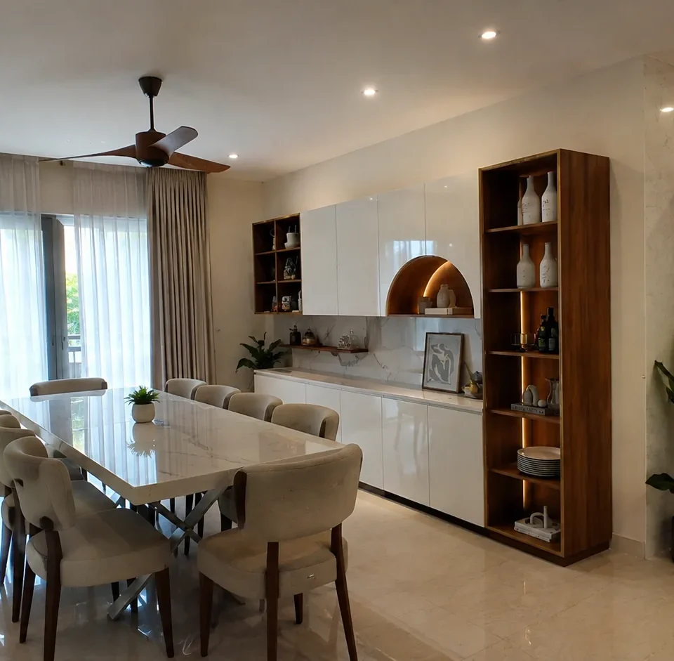 Dining area with a white marble-top table and cushioned chairs, a white and wood crockery display unit with an arched backlit niche, a marble backsplash and a fluted-glass partition.